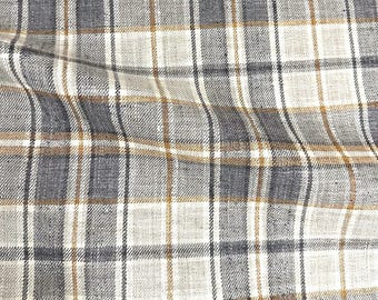 May include: A woven fabric featuring a plaid pattern with intersecting lines in shades of charcoal gray, light beige, and mustard yellow. The textile displays a visible cross-hatched texture with a consistent grid design throughout the material surface.