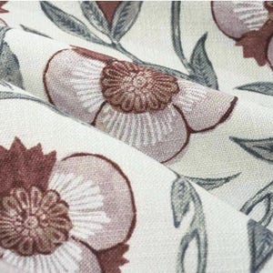 Dusty rose floral fabric with maroon detail designed for soft bedroom curtain enhancing cozy living space