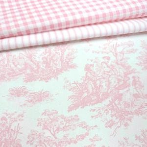 May include: A folded piece of fabric featuring a top section with a pink and white gingham check pattern and a bottom section with a pink and white toile de jouy print depicting pastoral scenes with figures, trees, and foliage on a white background.