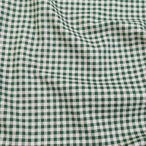 May include: A fabric featuring a classic gingham pattern with a repeating grid of dark forest green and white squares. The material displays soft folds and natural draping, highlighting the consistent woven texture of the checkered textile design.