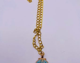Gold chain necklace with blue seashell pendent