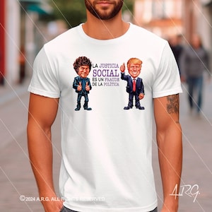 May include: White t-shirt featuring a cartoon image of two men. The text on the shirt reads "LA JUSTICIA SOCIAL ES UN FRAUDE DE LA POLITICA".