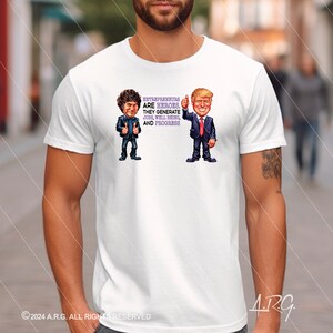 May include: White t-shirt with a cartoon illustration of two men. The text on the shirt reads "Entrepreneurs are heroes. They generate jobs, well being, and progress".