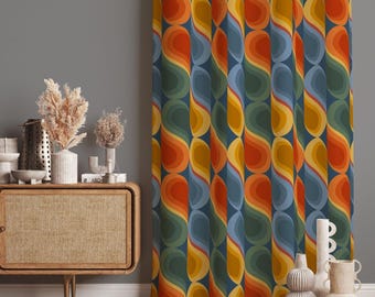 May include: A curtain featuring a repeating pattern of vertical, interlocking teardrop shapes in shades of orange, yellow, dark green, and blue. The fabric displays a continuous wave-like design with layered color gradients throughout the textile.
