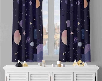 May include: Two dark blue curtains featuring a repeating pattern of planets, stars, and celestial shapes in shades of light pink, purple, and white. The curtains hang vertically, displaying a space-themed design with various circular and abstract forms.