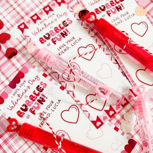 May include: Three Valentine's Day cards with bubble wands attached. Each card has a pink and red heart pattern and says "I hope your Valentine's Day is Bubbles of Fun!" with a space for a name.