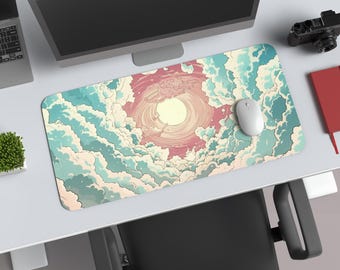 May include: A rectangular mouse pad featuring a stylized illustration of a sun surrounded by clouds in shades of blue, pink, and cream. A white computer mouse sits on the pad. The pad is on a white desk.