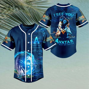 May include: A blue baseball jersey with a white trim and buttons. The front of the jersey features a blue and white image of a character from the movie Avatar: The Way of Water. The back of the jersey has the text "I See You" and "Avatar: The Way of Water".