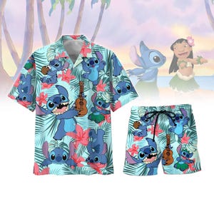May include: A light blue Hawaiian shirt and matching shorts set featuring a repeating pattern of the character Stitch, red flowers, and palm leaves. The shirt has a button-down front and short sleeves. The shorts have a drawstring waist. The background shows a beach scene.