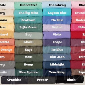 a collection of various colored t-shirts arranged in rows, each with a different color and text.
