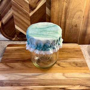 May include: A set of three ceramic mugs with a speckled, matte finish. The mugs are in shades of cream, light gray, and dark gray. Each mug has a simple, minimalist design, perfect for coffee or tea.