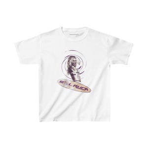 May include: White t-shirt with a graphic of a woman on a surfboard with the text "SOL RUCKA" in purple.