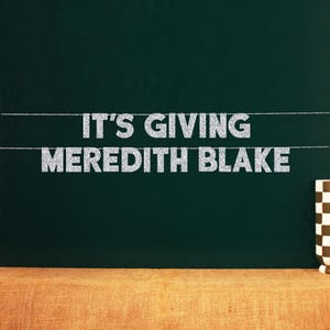 May include: A chalkboard with the text "It's giving Meredith Blake" written in silver glitter letters.