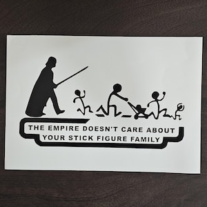 May include: Black and white sticker featuring a silhouette of Darth Vader with a lightsaber, chasing stick figures. The text reads "THE EMPIRE DOESN'T CARE ABOUT YOUR STICK FIGURE FAMILY."