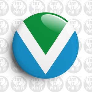 May include: A round button pin with a glossy finish. The pin features a design with a green top, a white inverted V-shape, and a blue bottom. The background is white with repeating "Say It Pin It" text.