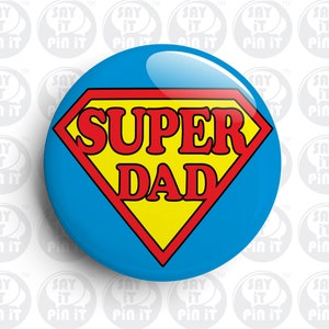 May include: A blue and red superhero badge with a yellow center. The badge says "SUPER DAD" in red letters.