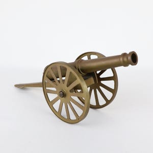 Field cannon model with brass barrel on a brass carriage with rolling brass wheels 12 inches long
