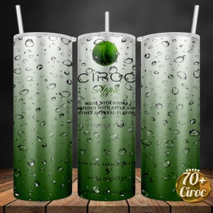 May include: A stainless steel tumbler with a green and silver design featuring the text "CIROC Apple" and "MADE WITH VODKA INFUSED WITH APPLE AND OTHER NATURAL FLAVORS IMPORTED FROM FINE FRENCH GRAPES 5 TIMES DISTILLED PRODUCT OF FRANCE". The tumbler has a green gradient with water droplets.