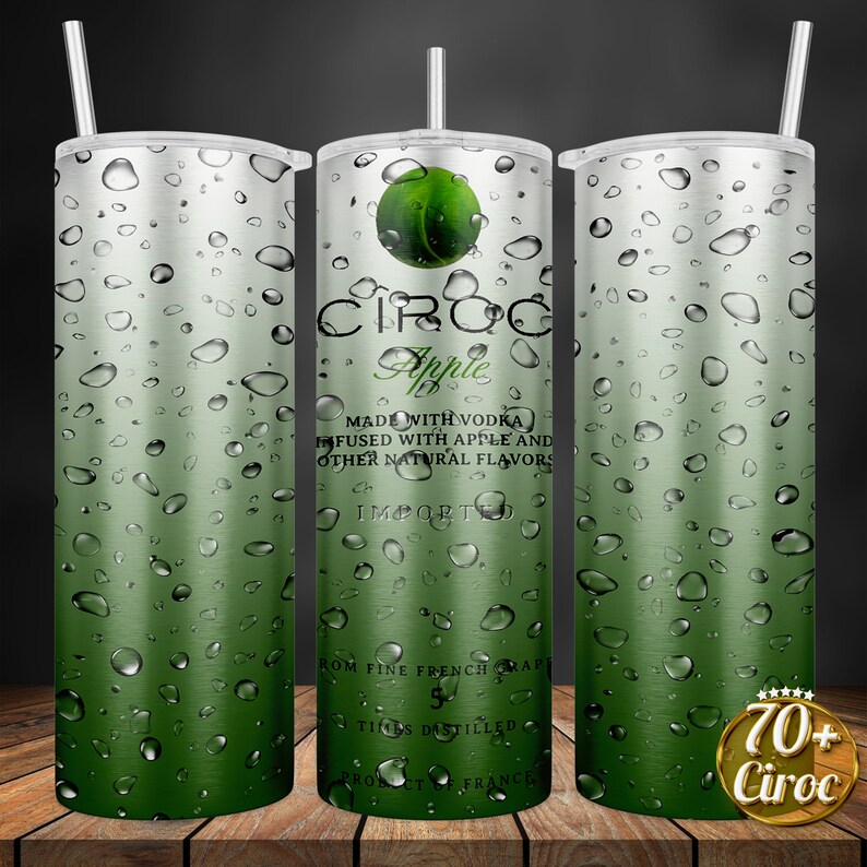 May include: A stainless steel tumbler with a green and silver design featuring the text "CIROC Apple" and "MADE WITH VODKA INFUSED WITH APPLE AND OTHER NATURAL FLAVORS IMPORTED FROM FINE FRENCH GRAPES 5 TIMES DISTILLED PRODUCT OF FRANCE". The tumbler has a green gradient with water droplets.