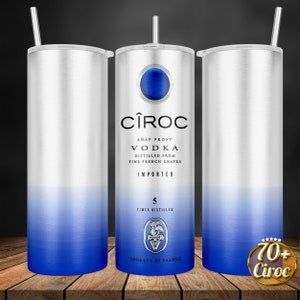 May include: A stainless steel tumbler with a blue to silver gradient design. The tumbler features the C&Icirc;ROC vodka logo and text, including "Snap Frost Vodka", "Distilled from Fine French Grapes", "Imported", "5 Times Distilled", and "Product of France".