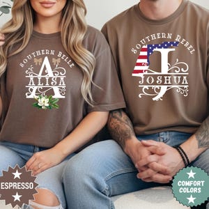 May include: Two brown t-shirts with custom designs. One says "Southern Belle Alisa" with floral accents. The other says "Southern Rebel Joshua" with a flag design. Both shirts are comfort colours.
