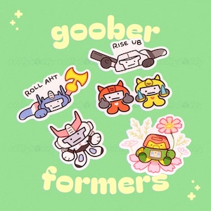 May include: A selection of cartoon robot stickers in various colours, with the words "goober" and "formers" in a playful font. The stickers are set against a light green background.