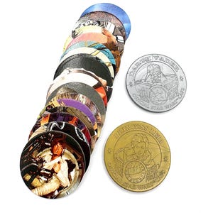 May include: A collection of circular Star Wars POGs, including a stack of various character designs and two individual metal caps. One silver cap features Darth Vader with the text Official Star Wars Caps, and one gold cap features Princess Leia.