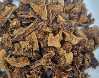 May include: A pile of dried, brown, and dark brown root bark pieces. The bark is irregularly shaped and has a rough texture.