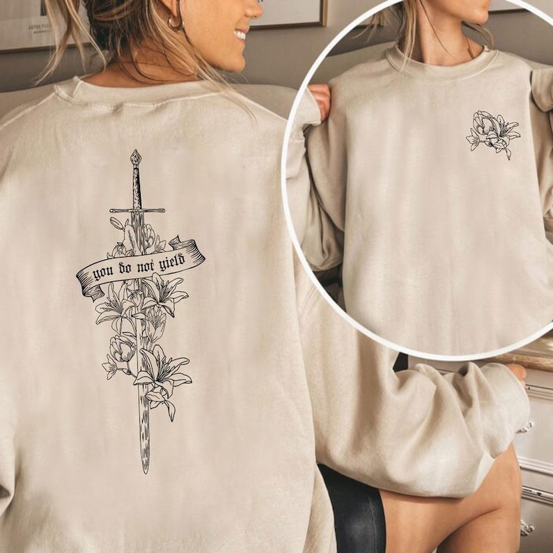 a woman wearing a sweatshirt with a cross on it