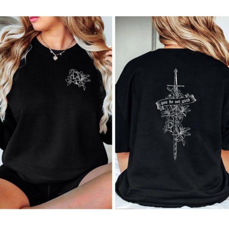 a woman wearing a black shirt with a cross on it