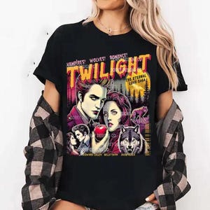 May include: Black t-shirt with a graphic print of the characters from the Twilight movie series. The graphic includes the text "Vampires! Wolves! Romance! Twilight The Eternal Love Saga" and features the characters Edward Cullen, Bella Swan, and Jacob Black.