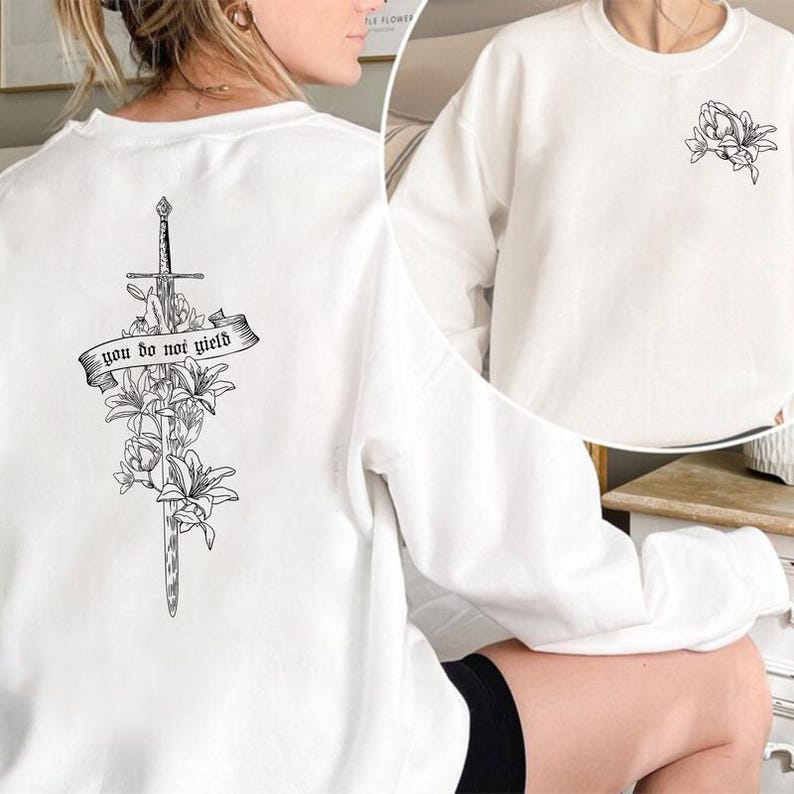 a woman wearing a sweatshirt with a cross on it