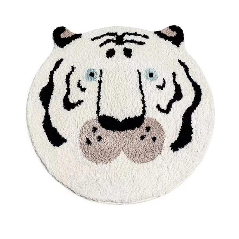 May include: White plush rug featuring a black and white tiger face design. The tiger has a black nose and brown whiskers.