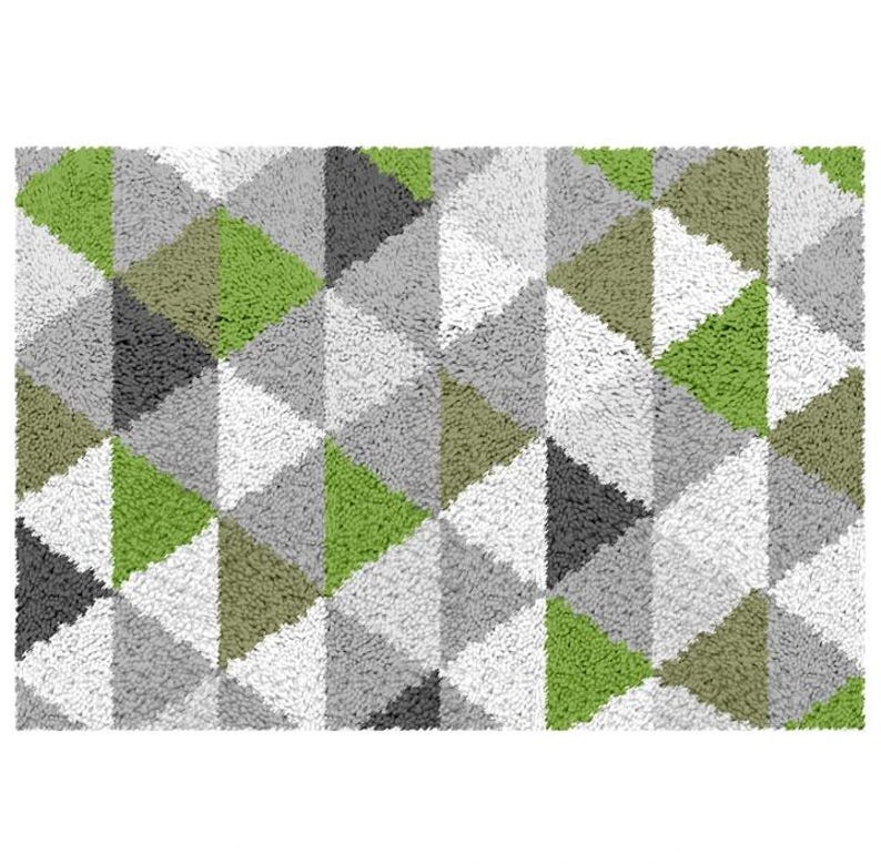 May include: A green, gray, and white geometric patterned rug with a fuzzy texture.