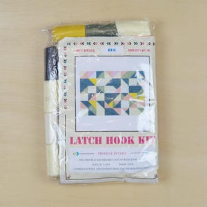 May include: A latch hook kit featuring a colourful geometric pattern. The kit includes yarn, a canvas, and instructions. Latch Hook Kit.