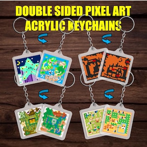 May include: Double-sided pixel art acrylic keychains with various colorful designs. Each keychain features a square, pixelated image on both sides, attached to a silver keyring. The keychains display different pixel art scenes, including a Christmas tree and maps.
