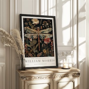 May include: A black framed poster with a vintage illustration of a dragonfly surrounded by flowers. The poster reads "19th Century Exhibition William Morris Textiles History of British Art & Design London".