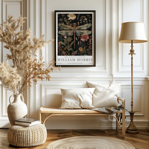 May include: A vintage poster featuring a dragonfly with intricate details, surrounded by flowers and foliage. The poster is framed in black and has the text "19th Century Exhibition William Morris" at the bottom.