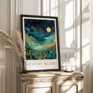 May include: A framed art print featuring a landscape painting with a night sky, mountains, and yellow flowers. The print is in a black frame and includes the text "GUSTAV KLIMT" and "20TH CENTURY EXHIBITION". The artwork is displayed on a decorative cabinet.