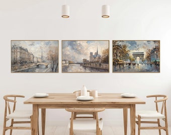 May include: Three framed paintings depicting scenes from Paris, France. The paintings are in a muted colour palette of greys, browns, and blues. The first painting shows a view of the Seine River with buildings and a bridge in the background. The second painting shows a view of the Notre Dame Cathedral with the Seine River in the foreground. The third painting shows a view of the Arc de Triomphe with people walking in the street.