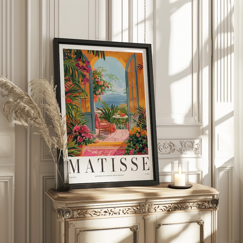 May include: A framed poster with a colorful painting of a patio scene with a view of the ocean. The poster has the text "MATISSE" in large black letters at the bottom. The poster is titled "Masters of French Art & Design".