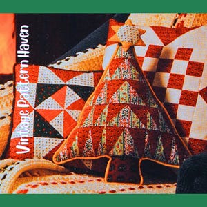 May include: A Christmas tree-shaped pillow with a star on top, made of red fabric with a floral pattern. The pillow is surrounded by other pillows with red and white geometric patterns. The text "Vintage Pattern Haven" is printed vertically on the left side.