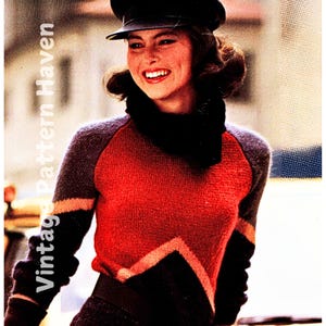 May include: A red, black and pink knitted sweater with a geometric pattern. The sweater has a turtleneck and long sleeves.