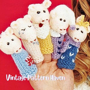 May include: Five knitted sheep finger puppets in various colours, including blue, yellow, and purple. Each puppet has cream-coloured wool and black eyes. The text "Vintage Pattern Haven" is visible at the bottom of the image.