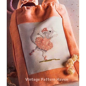 May include: A vintage cross-stitch pattern for a shoe bag featuring a ballerina mouse in a pink tutu. The bag is made of orange fabric with a white cross-stitch panel. The text "Vintage Pattern Haven" is printed on the bottom of the bag.
