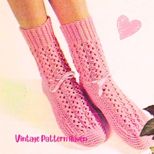 May include: A pair of pink knitted socks with a decorative openwork pattern and small white bows. The socks are displayed on a light background with a pink heart and the text "Vintage Pattern Haven".
