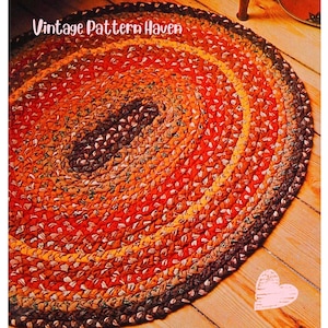 Könnte beinhalten: Ovaler geflochtener Teppich in Orange-, Braun- und Gelbtönen. Der Teppich hat ein konzentrisches Design mit einer dunkelbraunen Mitte, die zu helleren Farbtönen verblasst. Der Text "Vintage Pattern Haven" befindet sich in der oberen linken Ecke.
