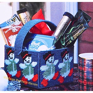 May include: A blue plastic tote bag with a handle, filled with various items, including a box of Lindt truffles, a tube of chocolate almond spread, and a package of cocoa powder. The tote bag is decorated with a pattern of four blue and green turtles with red hearts.
