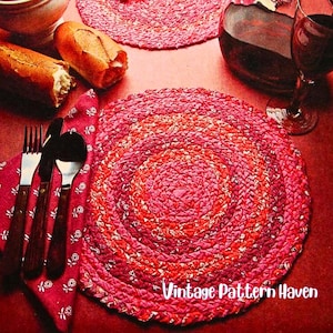 Puede incluir: Primer plano de un ajuste de mesa con un mantel individual trenzado rojo y rosa. El mantel individual está rodeado por una servilleta roja con cubiertos, pan y una copa de vino. El texto "Vintage Pattern Haven" es visible.