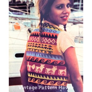 May include: A colorful crocheted vest with a geometric pattern and animal motifs. The vest is worn by a person with long blonde hair in pigtails.
